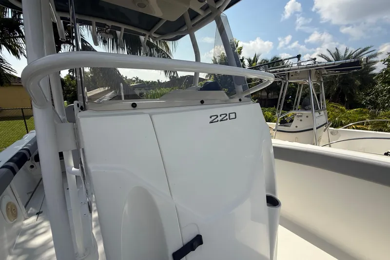 Slide: The Image of 2020 Striper 220 Center Console boat with sleek design, surrounded by tropical greenery. - 41