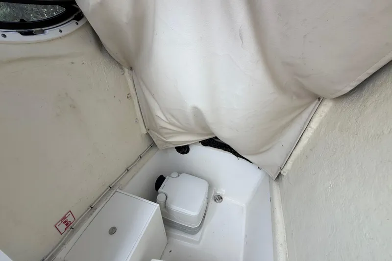 Slide: The Image of Interior of a 2020 Striper 220 Center Console boat with a compact marine toilet. - 42