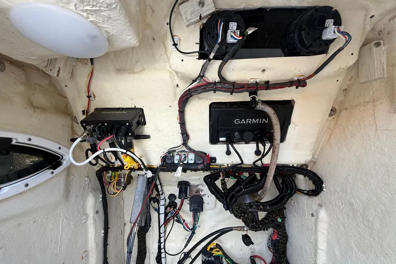 Slide: The Image of Electrical wiring and Garmin devices inside a 2020 Striper 220 Center Console boat. - 43