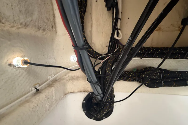 Slide: The Image of Wiring setup inside a 2020 Striper 220 Center Console boat, showcasing electrical cables and connections. - 44