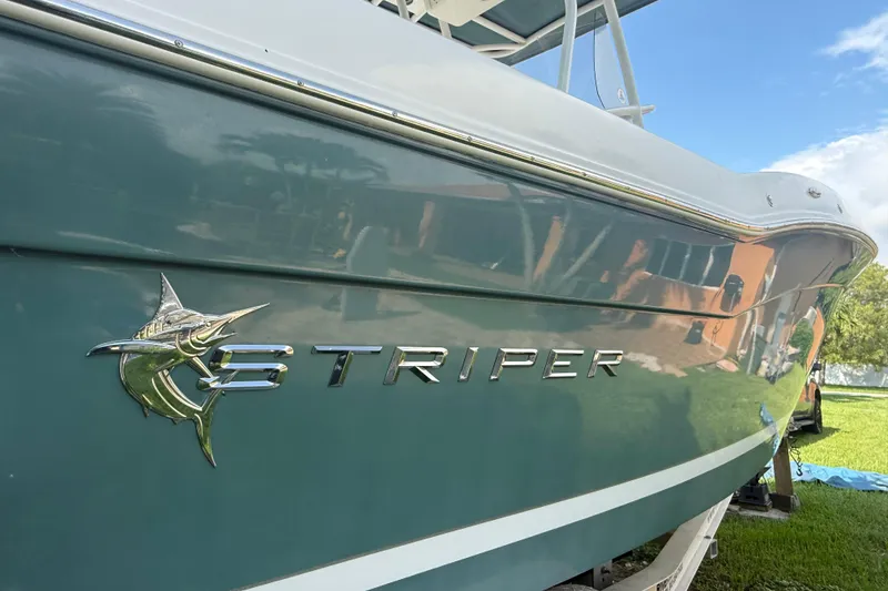 Slide: The Image of 2020 Striper 220 Center Console boat with marlin logo, side view. - 5