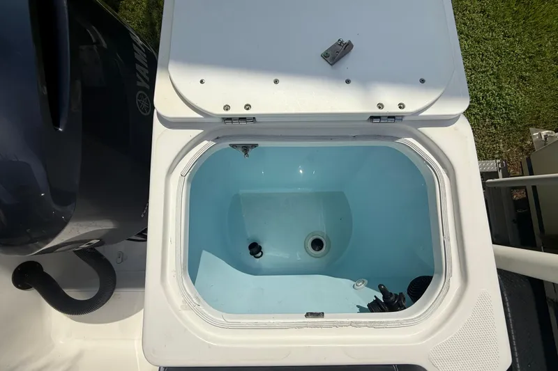 Slide: The Image of Open livewell on 2020 Striper 220 Center Console boat, showing interior and Yamaha engine. - 51