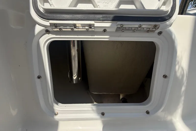 Slide: The Image of Open storage compartment on 2020 Striper 220 Center Console boat. - 53