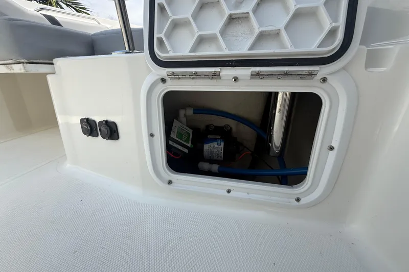 Slide: The Image of 2020 Striper 220 Center Console boat compartment with wiring and equipment. - 55