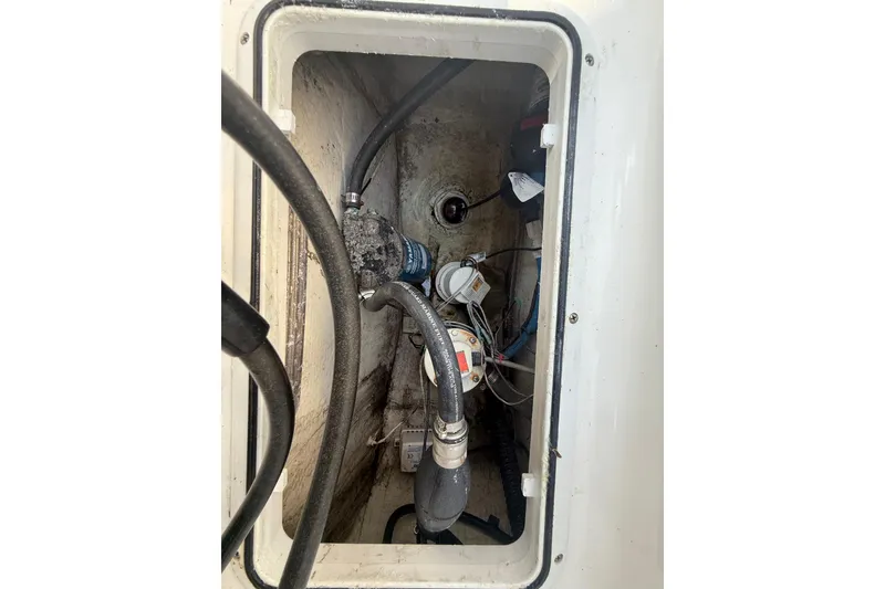 Slide: The Image of Bilge compartment of 2020 Striper 220 Center Console boat with hoses and pump. - 60