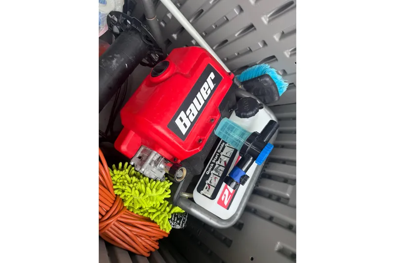 Slide: The Image of Storage compartment with Bauer equipment and cleaning supplies on a 2020 Striper 220 Center Console boat. - 66