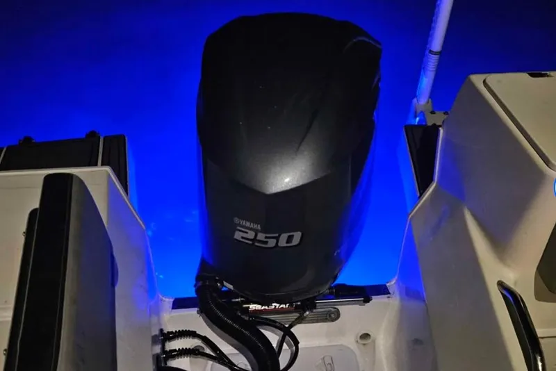 Slide: The Image of 2020 Striper 220 Center Console with Yamaha 250 engine, illuminated by blue underwater lights. - 71