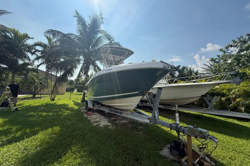 Slide: The Image of 2020 Striper 220 Center Console boat on trailer, surrounded by palm trees. - 9
