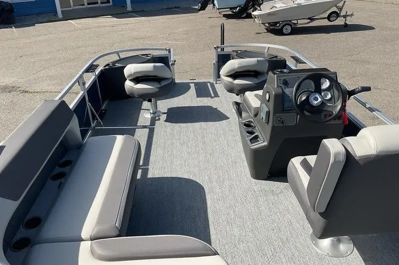 Slide: The Image of 2026 Sun Tracker BB 18 DLX pontoon boat interior with seating and steering console. - 11