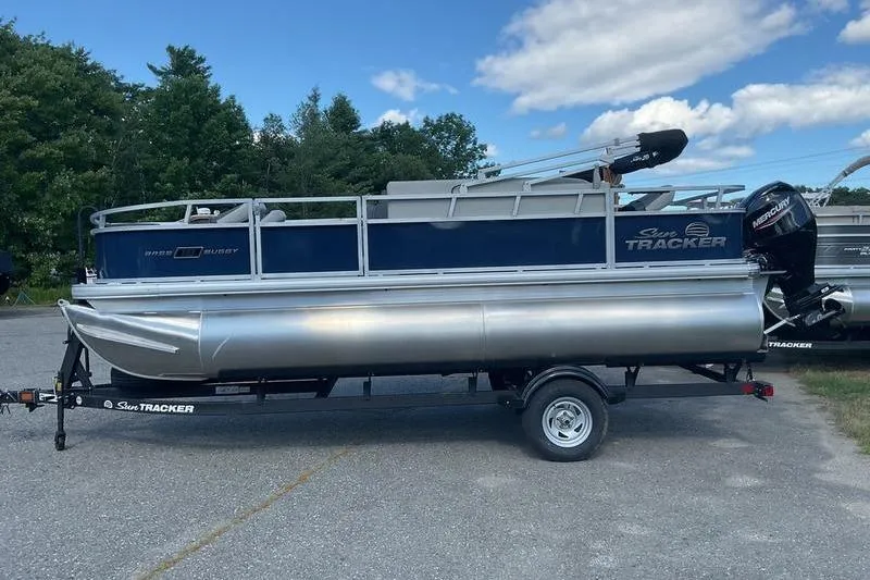 Slide: The Image of 2026 Sun Tracker BB 18 DLX pontoon boat on trailer, parked outdoors. - 3