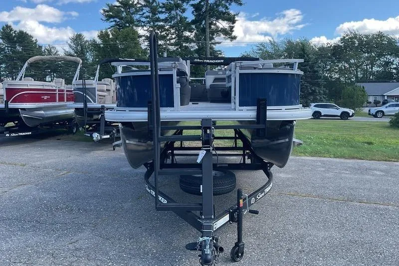 Slide: The Image of 2026 Sun Tracker BB 18 DLX pontoon boat on trailer, parked outdoors. - 4
