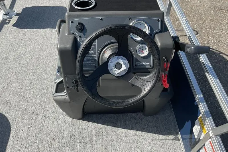 Slide: The Image of Steering console of 2026 Sun Tracker BB 18 DLX boat with gauges and controls. - 5