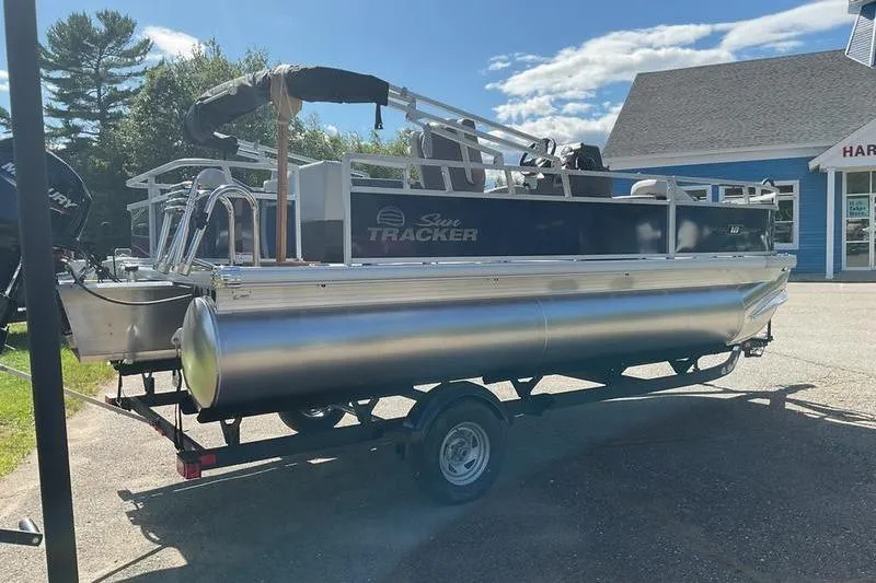 Slide: The Image of 2026 Sun Tracker BB 18 DLX pontoon boat on trailer, parked outdoors. - 6