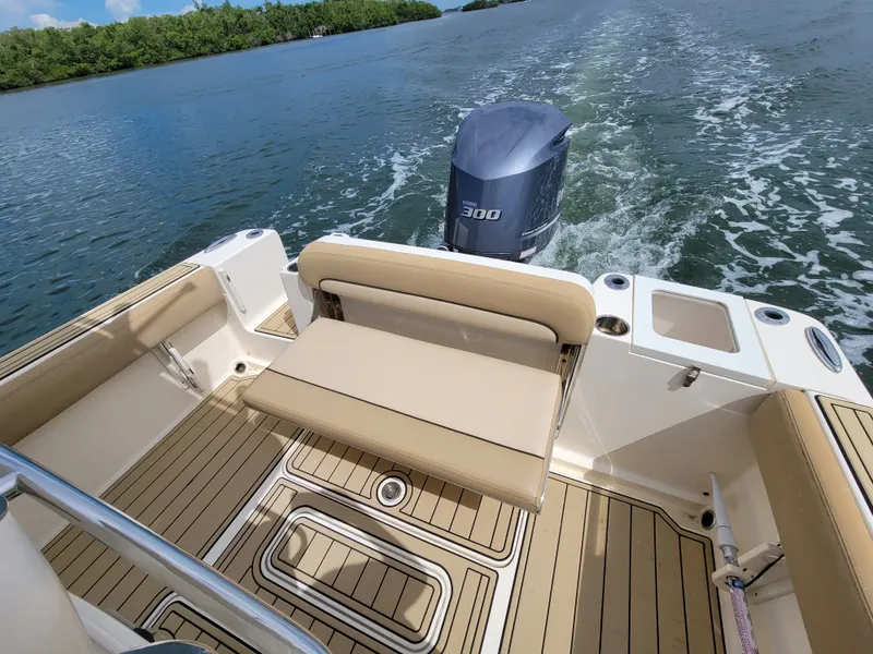 Slide: The Image of 2018 Scout 235XSF boat interior with Yamaha 300 engine on water. - 7