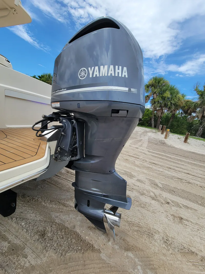 Slide: The Image of 2018 Scout 235XSF boat with Yamaha outboard motor on sandy beach. - 8