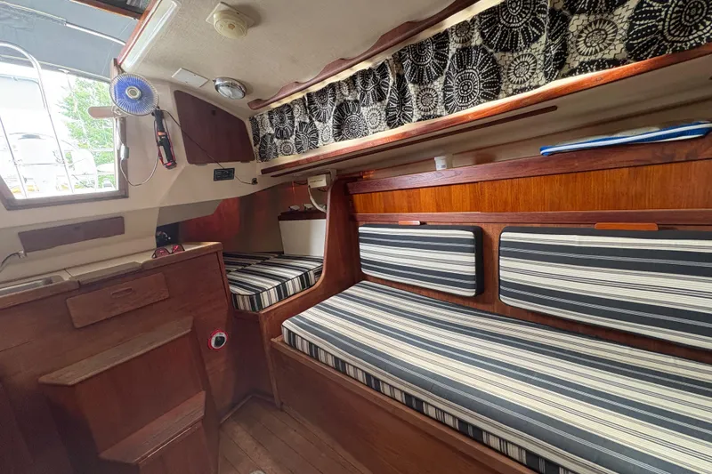 Slide: The Image of Interior of 1981 Sabre 31 sailboat with striped cushions and wooden cabinetry. - 101