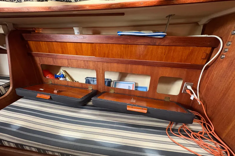 Slide: The Image of Interior of a 1981 Sabre 31 sailboat with wooden storage compartments. - 103