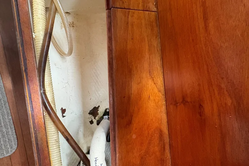 Slide: The Image of Interior of 1981 Sabre 31 sailboat showing wood paneling and hoses. - 104