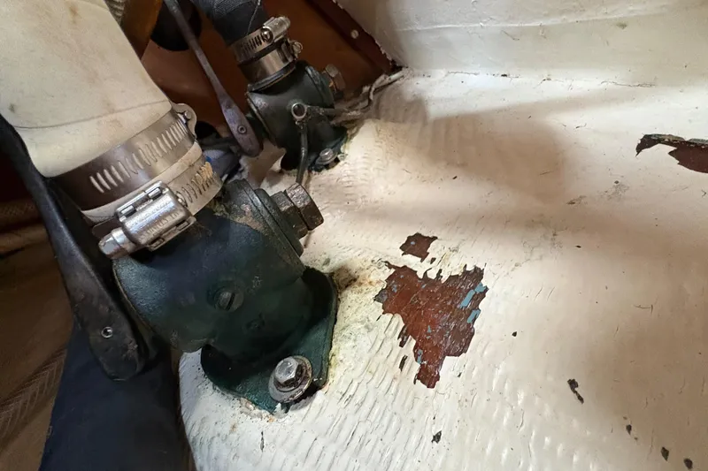 Slide: The Image of Aging plumbing components on a 1981 Sabre 31 boat with peeling paint. - 106
