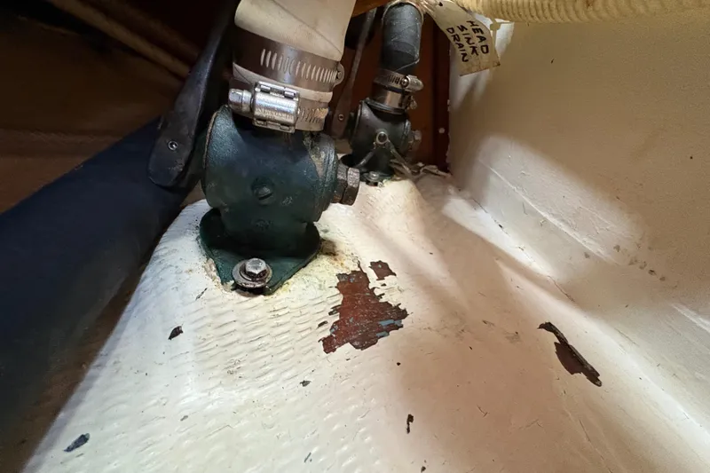 Slide: The Image of Close-up of a 1981 Sabre 31 boat's interior plumbing with visible wear. - 107