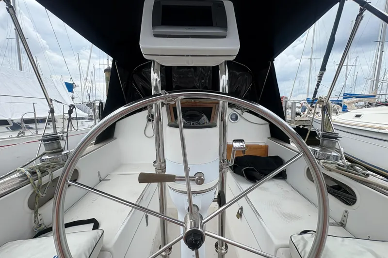 Slide: The Image of 1981 Sabre 31 sailboat cockpit with steering wheel, docked at marina. - 11