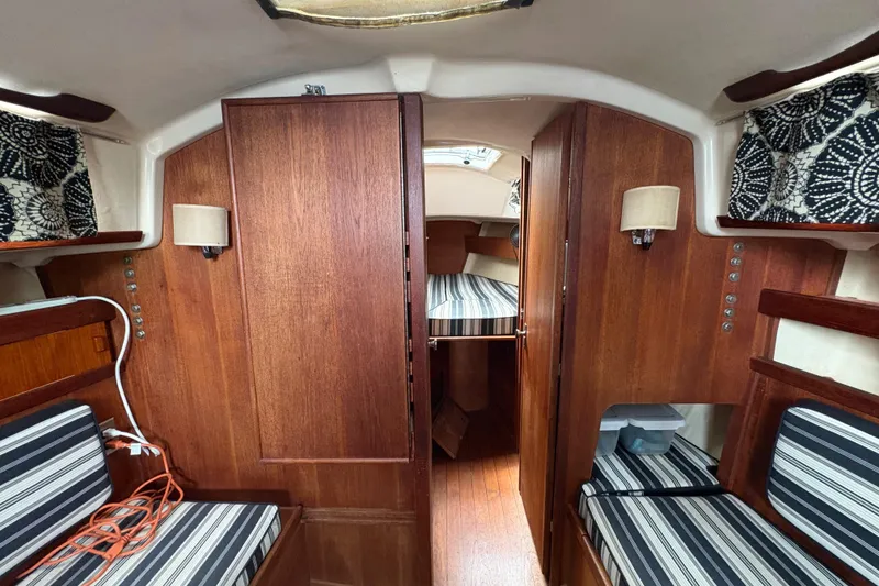 Slide: The Image of Interior of 1981 Sabre 31 sailboat with wood paneling and striped cushions. - 110
