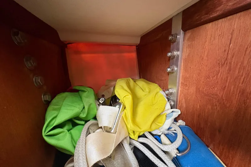Slide: The Image of Interior of 1981 Sabre 31 sailboat with colorful ropes and fabric storage. - 112