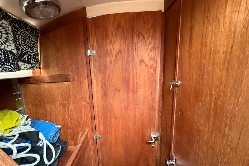 Slide: The Image of Interior of 1981 Sabre 31 sailboat with wooden cabinetry and storage area. - 114
