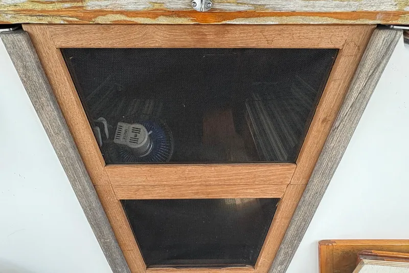 Slide: The Image of Wooden framed hatch with mesh screen on a 1981 Sabre 31 boat. - 12