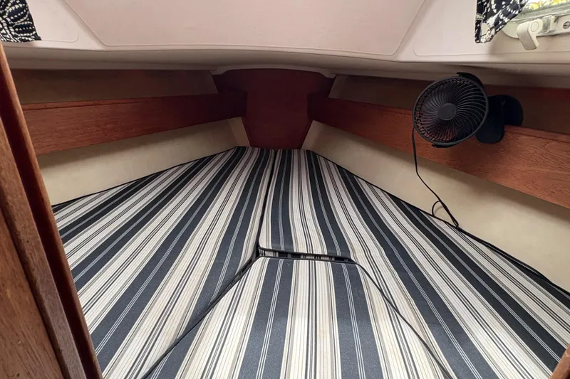 Slide: The Image of Interior of 1981 Sabre 31 sailboat with striped bedding and small fan. - 121