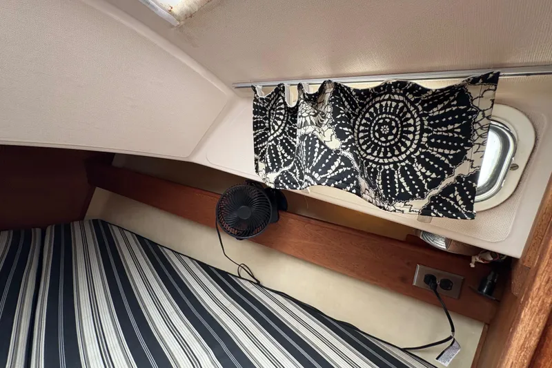 Slide: The Image of Interior of 1981 Sabre 31 sailboat with striped bedding and patterned curtain. - 124