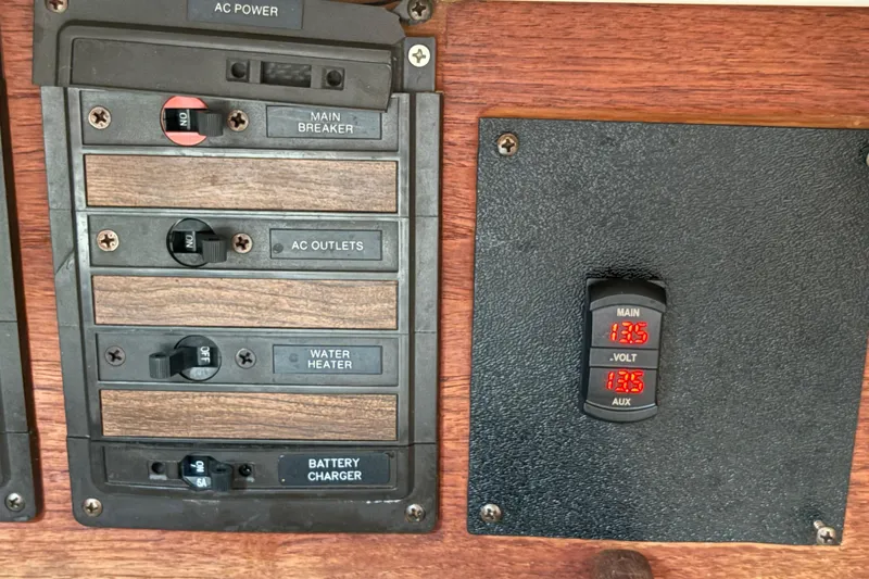 Slide: The Image of Electrical panel of a 1981 Sabre 31 boat with voltage display and switches. - 131