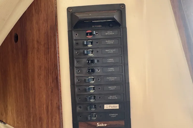 Slide: The Image of Electrical panel on a 1981 Sabre 31 sailboat with labeled switches for various functions. - 134