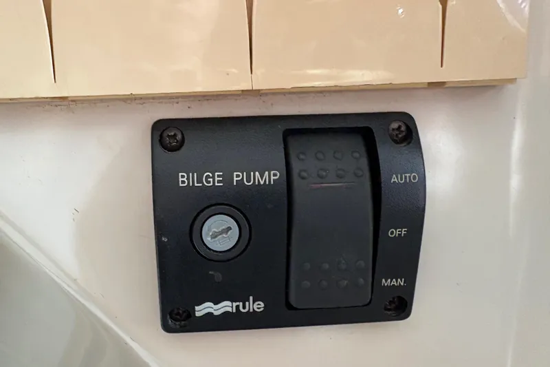 Slide: The Image of Bilge pump control panel on 1981 Sabre 31 boat, featuring auto, off, and manual settings. - 135