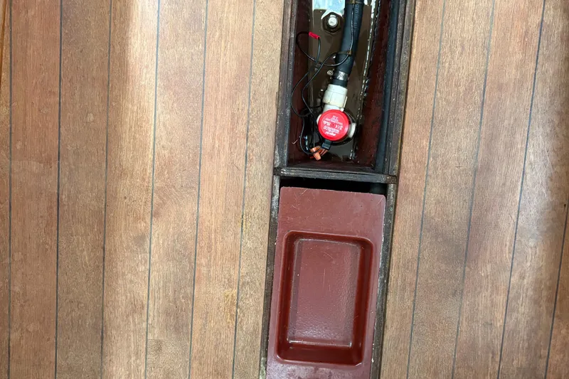 Slide: The Image of Wooden floor with open compartments on a 1981 Sabre 31 boat. - 140