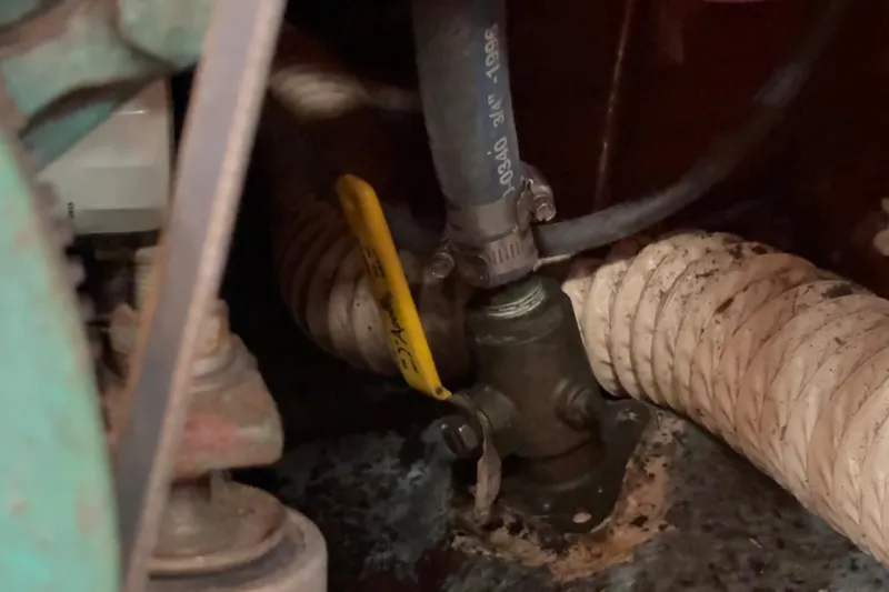 Slide: The Image of Engine compartment of a 1981 Sabre 31 sailboat showing hoses and fittings. - 141