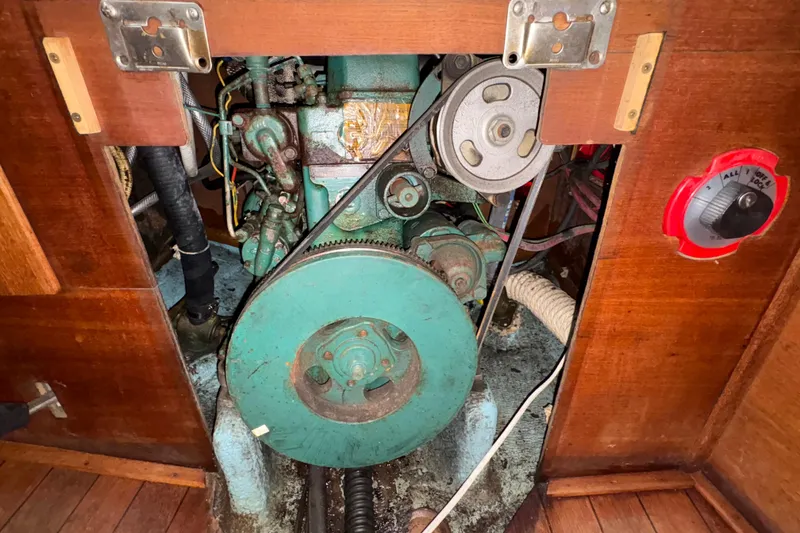 Slide: The Image of Engine compartment of a 1981 Sabre 31 sailboat, featuring a visible belt and pulley system. - 142