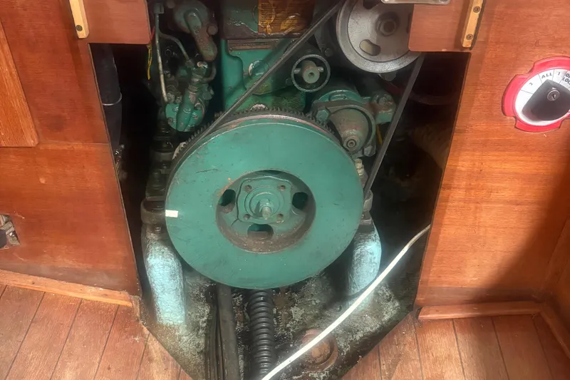 Slide: The Image of Engine compartment of a 1981 Sabre 31 sailboat, featuring a green marine engine. - 143