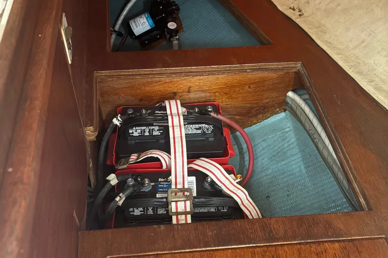 Slide: The Image of Battery compartment of a 1981 Sabre 31 sailboat, featuring secured DieHard batteries. - 144