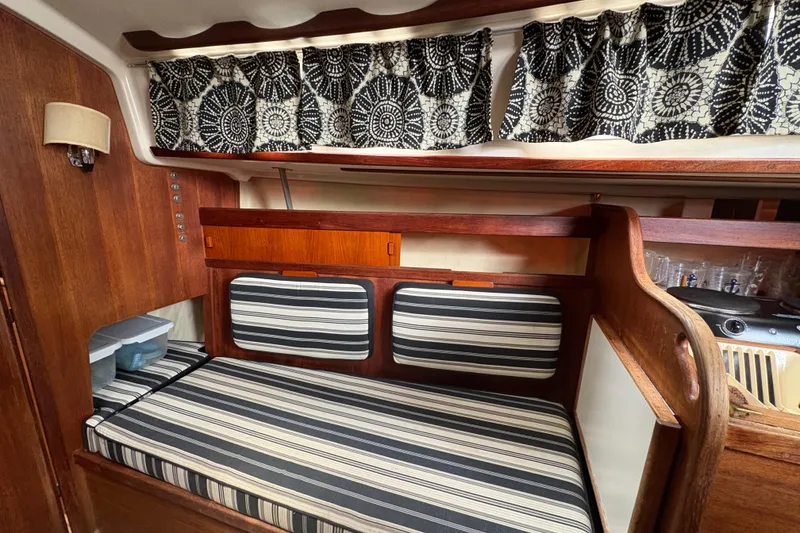 Slide: The Image of Interior of 1981 Sabre 31 sailboat with striped cushions and patterned curtains. - 18