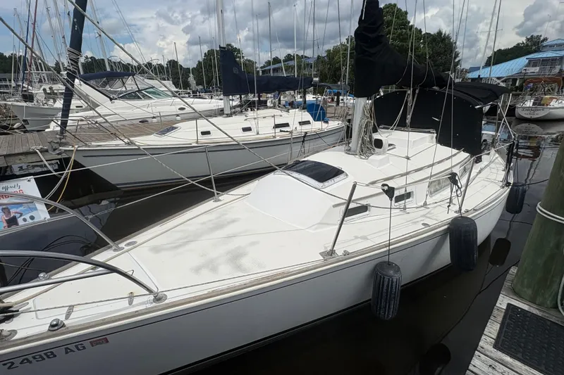 Slide: The Image of 1981 Sabre 31 sailboat docked at marina, surrounded by other boats. - 34