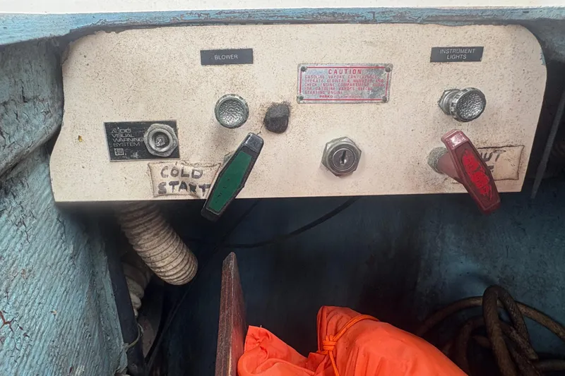 Slide: The Image of Control panel of a 1981 Sabre 31 boat with labeled switches and knobs. - 39