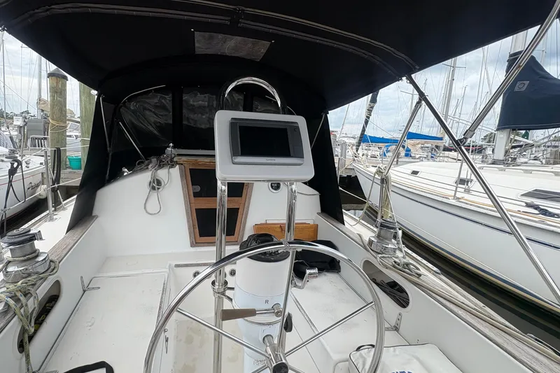 Slide: The Image of Cockpit of a 1981 Sabre 31 sailboat with steering wheel and navigation equipment. - 42