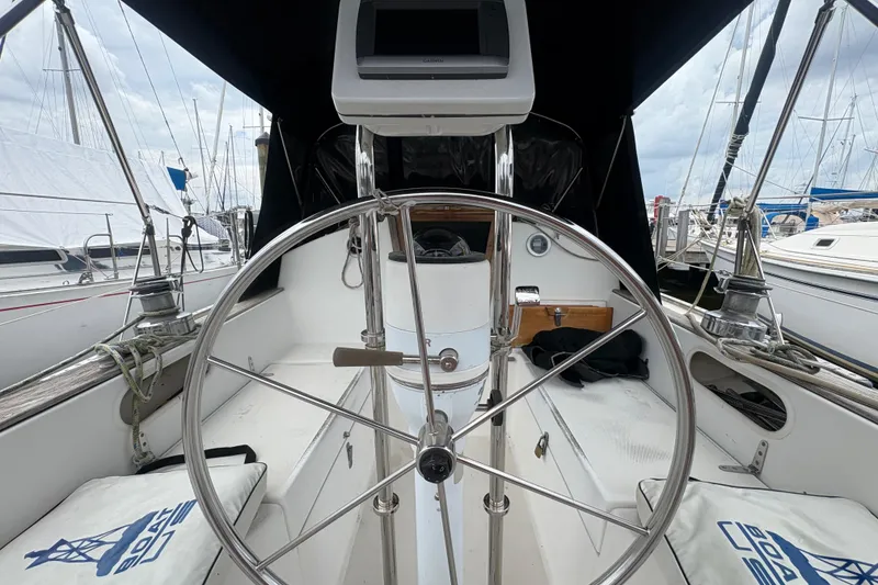 Slide: The Image of Cockpit of a 1981 Sabre 31 sailboat with steering wheel and navigation equipment. - 45