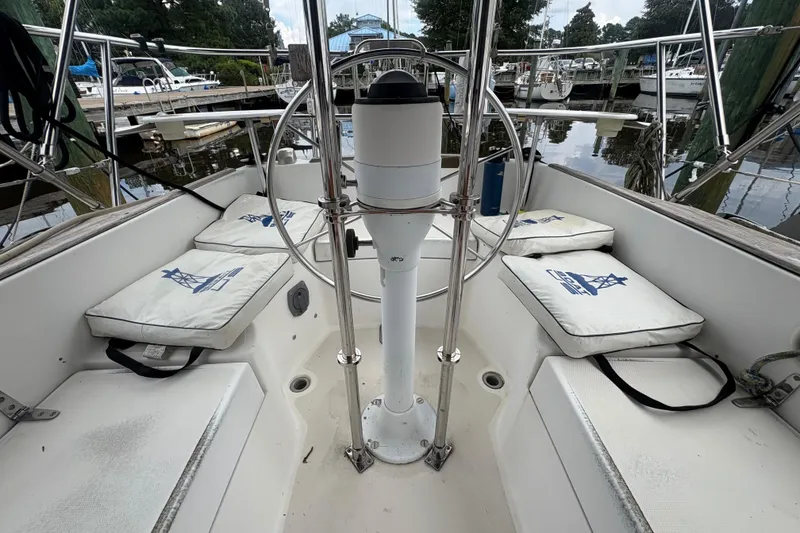 Slide: The Image of Cockpit of 1981 Sabre 31 sailboat with cushioned seating and steering wheel. - 47
