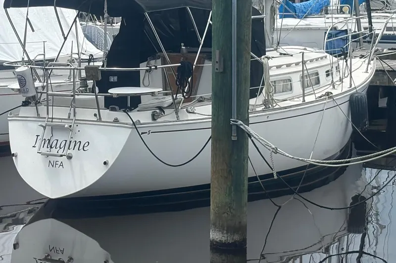 Slide: The Image of 1981 Sabre 31 sailboat named "Imagine" docked at a marina. - 6