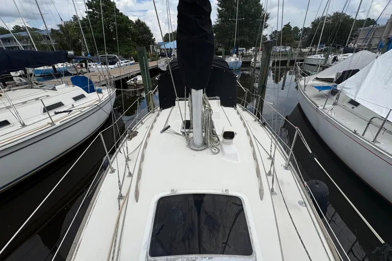 Slide: The Image of 1981 Sabre 31 sailboat docked, view of deck and rigging in marina setting. - 60