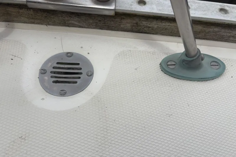 Slide: The Image of Deck detail of a 1981 Sabre 31 sailboat, featuring a metal drain and fitting. - 72