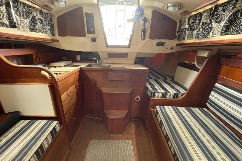 Slide: The Image of Interior of 1981 Sabre 31 sailboat with wood finish and striped cushions. - 79