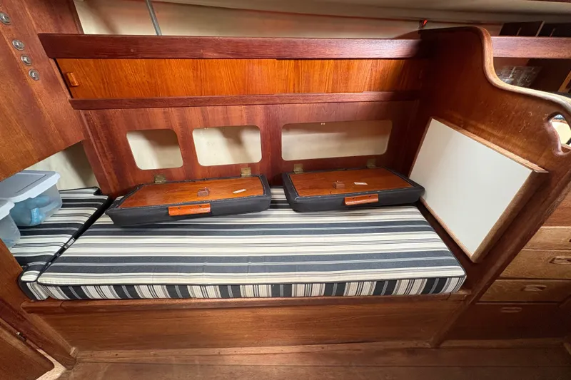 Slide: The Image of Interior of a 1981 Sabre 31 sailboat with striped cushion and wooden cabinetry. - 81